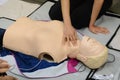 Check pulse - CPR First Aid Training with CPR dummy in the class