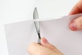 Check sharpening blades medical scalpel on paper Royalty Free Stock Photo