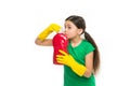 Check smell. Girl in rubber gloves for cleaning hold big plastic bottle chemical soap liquid white background. Use