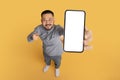 Check This. Smiling Asian Man Pointing At Big Blank Smartphone In Hand Royalty Free Stock Photo