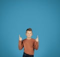 Check This. Smiling preteen boy pointing up at copy space above head Royalty Free Stock Photo