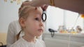 Check up of eyesight in child`s ophthalmology - optometrist diagnosis little girl