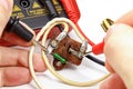 Check vintage resistor with multimeter on a white background