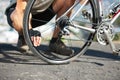 Check, wheel and hand on bicycle with road, street and outdoor exercise with flat tire. Cycling, athlete and closeup on