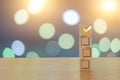 Check your choice on 4 wooden cubes on a beautiful bokeh background