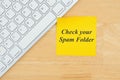 Check your spam folder text on a sticky note with a keyboard Royalty Free Stock Photo