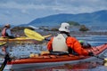 Kayakers in colorful gear rest in the leeward side of a reef near Checkaklis Island