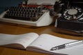 Checkbook, ink pen, retro typewriter and old telephone on the table. . Selected focus Royalty Free Stock Photo