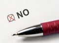 checkbox NO. marked with red cross and pen on white paper background. Checking NO. pen over document select No Royalty Free Stock Photo