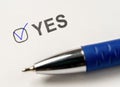 checkbox YES. marked with tick mark and blue pen on white paper background. Vote Yes. answer choice Yes. vote for, confirmation,