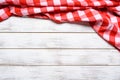 A checked gingham picnic tablecloth on old wooden table top view Royalty Free Stock Photo