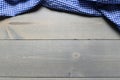 A checked gingham picnic tablecloth on old wooden table top view Royalty Free Stock Photo