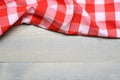 A checked gingham picnic tablecloth on old wooden table top view Royalty Free Stock Photo