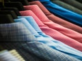 Checked men`s shirts hanging on rack.