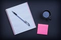 Checked notepad pen sticky note and cup of coffee Royalty Free Stock Photo