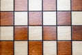 Checkerboard, chessboard detail - top view squares, wooden background Royalty Free Stock Photo
