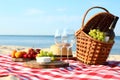 Checkered blanket with picnic basket and products