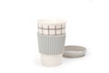 Checkered ceramic cup with rubber lid, shot against a white background