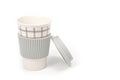 Checkered ceramic cup with rubber lid, shot against a white background