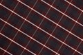 Checkered fabric pattern in deep red and black tones with diagonal lines and texture Royalty Free Stock Photo