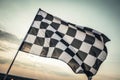Checkered finishing flag waving in the wind against sky Royalty Free Stock Photo
