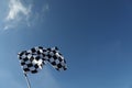 Checkered flag against blue sky outdoors, low angle view. Space for text Royalty Free Stock Photo