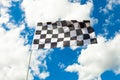 Checkered flag on flagpole waving in the wind Royalty Free Stock Photo