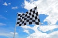 Checkered flag old condition on flagpole waving in the wind with clouds on background Royalty Free Stock Photo