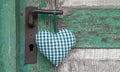 Checkered green heart shape hanging on door handle for wedding, Royalty Free Stock Photo