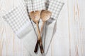 Checkered kitchen towel and kitchen tools on vintage wooden background. Selective focus. Place for text. Royalty Free Stock Photo