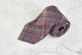 Checkered neck tie on marble background Royalty Free Stock Photo