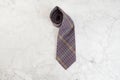 Checkered neck tie on marble background Royalty Free Stock Photo
