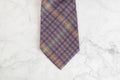 Checkered neck tie on marble background Royalty Free Stock Photo