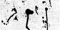Checkered notebook paper with messy ink spray splatter, tiny black stains