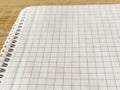 Checkered notebook with spiral. An open notepad for notes. Soft focus. Copy space. Blank blank page for your text Royalty Free Stock Photo