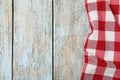 Checkered picnic blanket on wooden background. Space for text Royalty Free Stock Photo