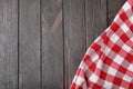 Checkered picnic blanket on wooden background. Space for text Royalty Free Stock Photo