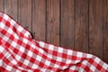 Checkered picnic blanket on wooden background. Space for text Royalty Free Stock Photo