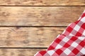 Checkered picnic blanket on wooden background. Space for text Royalty Free Stock Photo