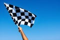 checkered race flag in hand. Royalty Free Stock Photo