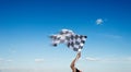 Checkered race flag in hand Royalty Free Stock Photo