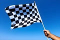 checkered race flag in hand. Royalty Free Stock Photo