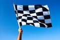 checkered race flag in hand. Royalty Free Stock Photo