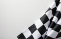 Checkered racing flag with black and white squares draped on a plain white Royalty Free Stock Photo
