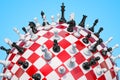Checkered sphere, chess board with chess pieces. 3D rendering