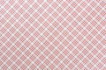 Checkered tablecloth or napkin with red stripes on a white background. Close-up