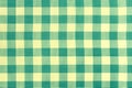 Checkered tablecloth for the table light yellow and green cells pattern. Background texture of olive textile napkin Royalty Free Stock Photo