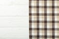 Checkered tablecloth on wooden background, space for text Royalty Free Stock Photo