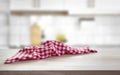 Checkered towel on wooden table blurred kitchen background. Picnic cloth empty space Royalty Free Stock Photo