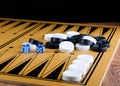 Checkers and dices on backgammon board Royalty Free Stock Photo